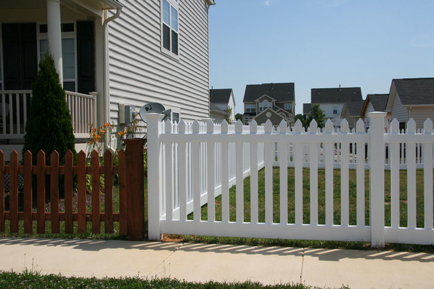 contemporary vinyl picket fence with wide space and flat top